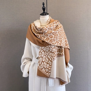 Detailed view of the leopard print texture and soft fringed edges of this thick winter scarf