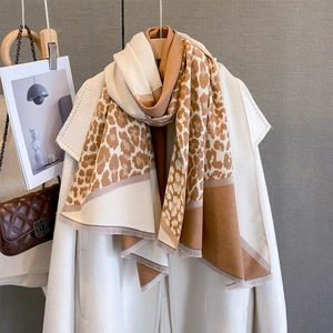 Thick autumn leopard print scarf wrap with beige color blocking on a white coat