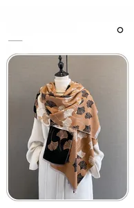 Detail of imitation cashmere scarf showing ginkgo leaf jacquard pattern and soft fringe
