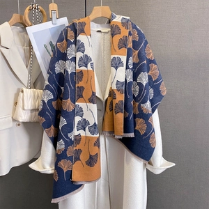 Detailed texture of ginkgo leaf jacquard scarf with short fringe and soft navy fabric