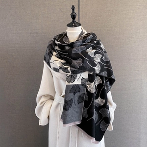 Detail of soft ginkgo leaf jacquard pattern on thick winter scarf with micro-fringes