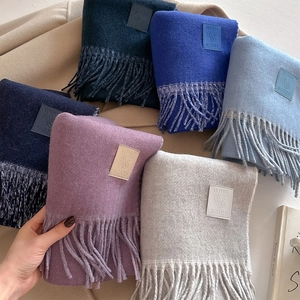 Wool blend scarf with tassel edge and leather label in multiple classic colors