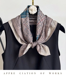 Détail de foulard en soie et laine avec pois géométriques et motif cheval sur robe noire