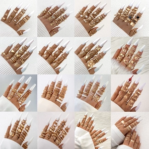 Collection of 16 gold ring sets with heart, star, and butterfly designs for stacked wear