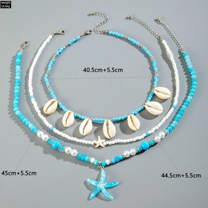 Ocean theme layered necklaces set with blue beads, sea shells and starfish charms