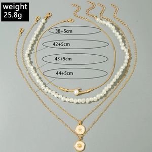 Detail of layered starfish and shell necklaces with beads and length specifications