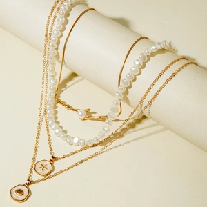 Detail of multilayer beaded necklace with starfish pendants and baroque pearls for vacation