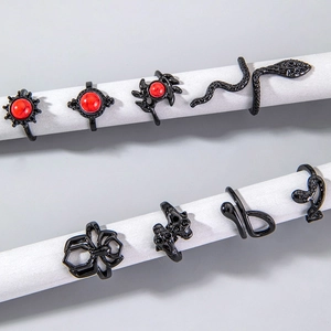 Detail view of 8-piece gothic punk ring set featuring black snake and spider designs