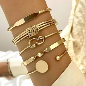 Luxury 6-piece gold metal bracelet set with diverse textured designs on female wrist