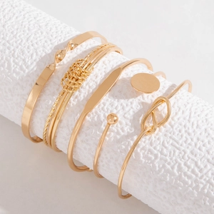 6-piece gold metal bracelet set featuring arrow, wave, and twisted textured designs