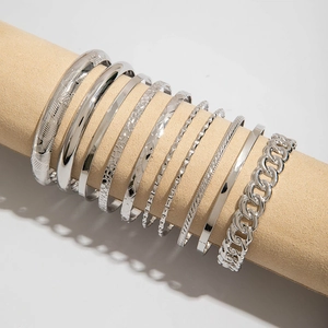 Detailed view of 9-piece silver cuff bracelet set with geometric patterns and chain links