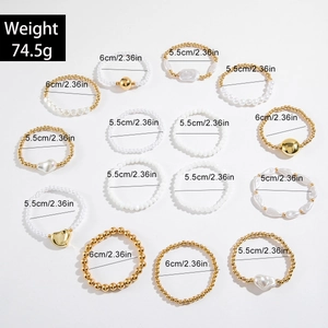 Dettaglio del set di 14 bracciali elastici in oro e bianco con ciondoli decorativi