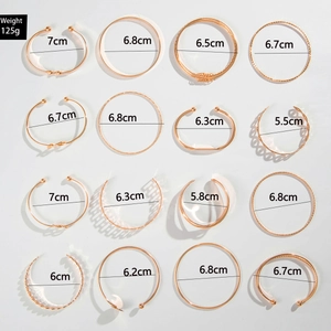 Macro view of 16-piece gold alloy bracelet set showing textured patterns and sizes