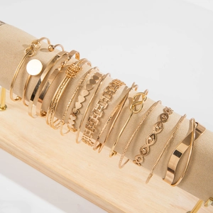 Detailed set of twelve gold-plated bangles with twisted and geometric patterns on a display