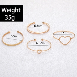 Detailed size specifications for 4-piece gold bangle set with knot and heart motifs
