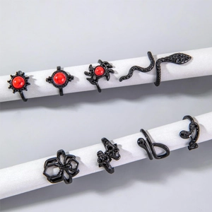 Gothic black alloy rings set featuring snake, spider, and skull designs with red gemstones