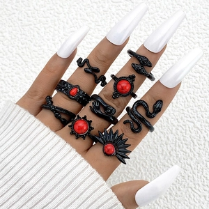 10-piece Gothic black metal ring set with red gems featuring snakes and sun patterns