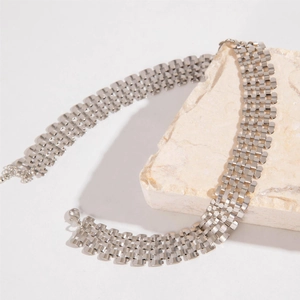 Detailansicht der silbernen Netzhalskette mit Karabinerverschluss auf einem Stein