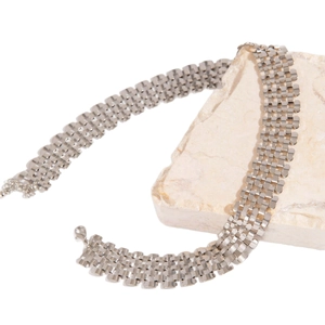 Silver wide punk choker necklace with chunky metallic mesh chain on white stone base