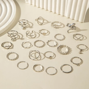 Flachbild von silbernen Stapelringen im Set mit Herz-, Schlangen- und Perlendesigns