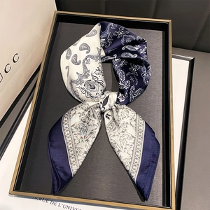Classic navy and white paisley print silk scarf displayed in an elegant gift tray