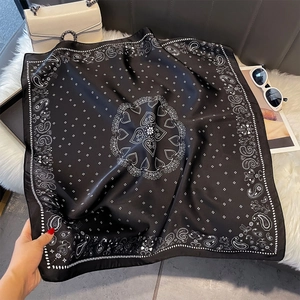 Close-up of black and white paisley heart silk scarf with premium edge stitching detail
