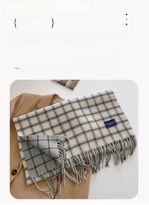 Detail of soft plaid scarf with fringe and 'Elegant & Classic' label, size 206x54cm