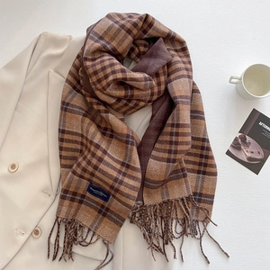 Detail of plaid scarf with tassels on beige blazer, featuring Elegant & Classic label