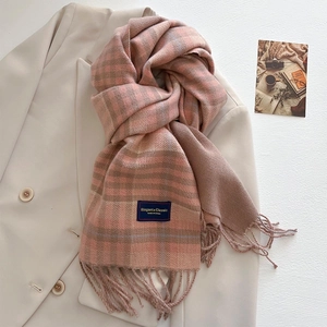 Detail of pink and brown plaid scarf with fringe tassels and elegant product tag