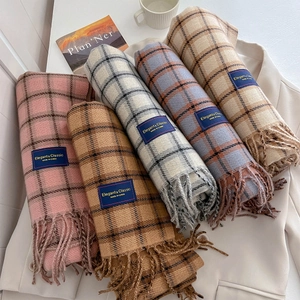 Classic checkered fringe scarves in five colors displayed on a beige autumn blazer