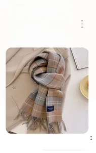 Detail of classic plaid tassel scarf with Elegant & Classic tag on thick warm fabric