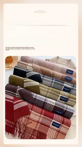 Close-up of stacked colorful checkered scarves with elegant tassels and soft texture