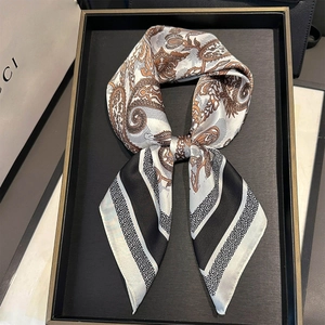 Detail of silk-like square scarf with paisley pattern and black-white striped border