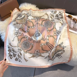 Detail of elegant silk-like square scarf featuring vintage European horse and chain patterns