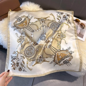 Close-up of elegant faux silk scarf with vintage carriage prints on a white plush rug