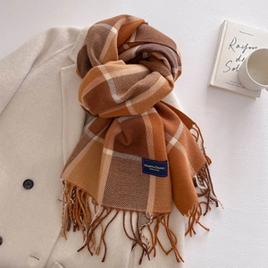 Detail of checkered cashmere-feel scarf with woven fringes and elegant woven label