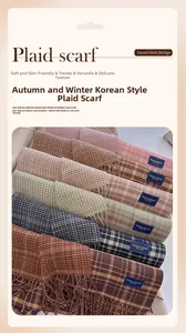 Detailed view of plaid scarves collection with fringed edges in various soft autumn colors