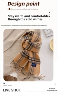 Detailed close-up of camel and black striped scarf with fringes on a wool coat