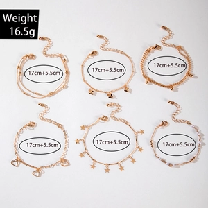 Detail of 6-piece gold charm bracelet set with stars and hearts weighing 16.5g