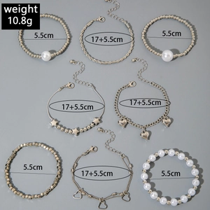 Detailed view of silver-tone multi-layered bracelet set with star and heart charms