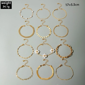 Detail view of 12-piece gold star heart tassel bead bracelet set with lobster clasp