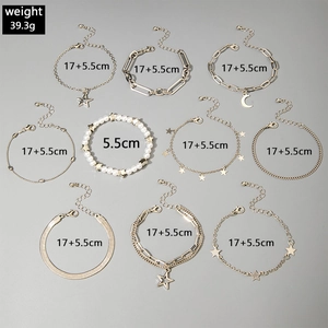Set of 10 golden star and moon charms bracelets with faux pearls and snake chains