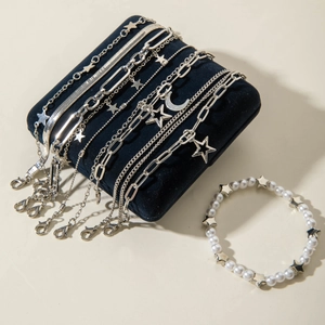 Detail of bohemian silver charm bracelet set with heart star charms on blue velvet pillow