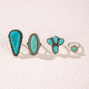 Detail of four bohemian rings with turquoise stones and vintage silver engravings