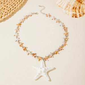 Detail of bohemian starfish necklace with shell elements and adjustable metal chain