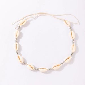 Close-up of Bohemian shell necklace with natural cowrie shells and silver beads
