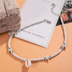 Detail of beach style necklace with white beads, starfish charms and shell pendant