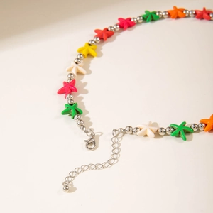 Detailed close-up of bohemian starfish beaded necklace with colorful charms and lobster clasp