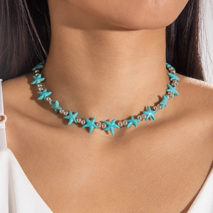Close-up of turquoise starfish beaded necklace on model neck for summer beach style