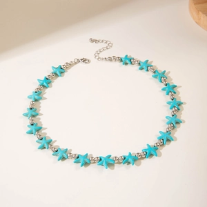 Close-up of bohemian starfish beaded necklace with turquoise stars and silver beads